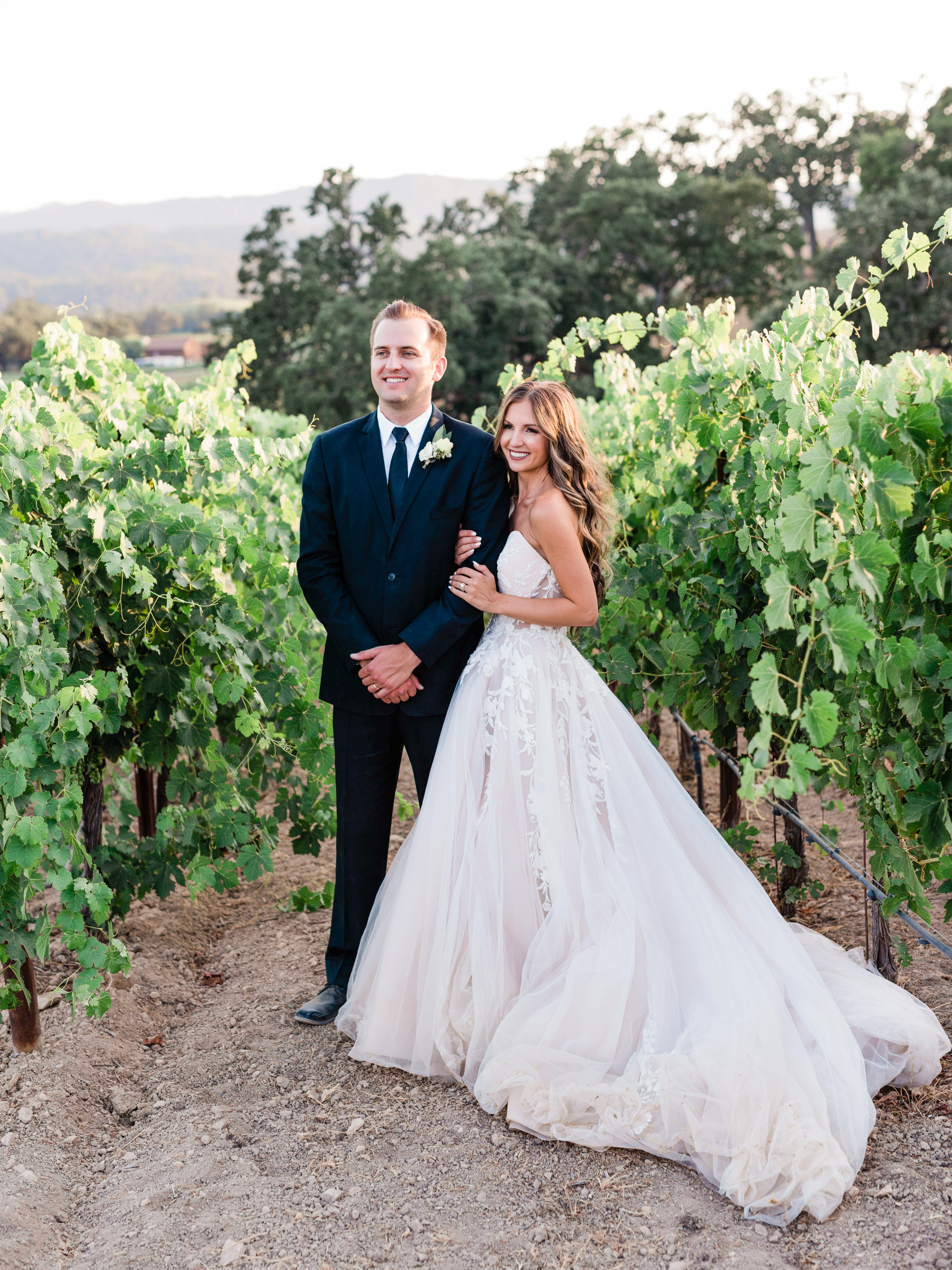a bride and groom in the vineyards at halter ranch winery on their wedding day