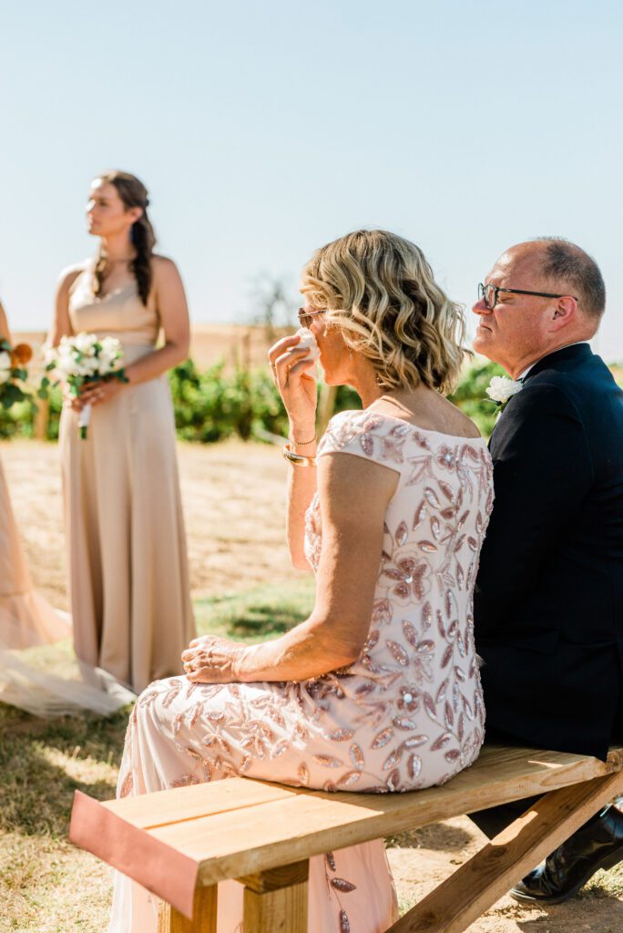 Candid moment of mother crying during Ella's Vineyard wedding ceremony in Paso Robles.