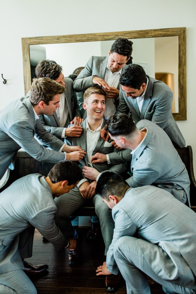 Groomsmen getting ready at Bella Terra Vineyards capturing by a Paso Robles luxury wedding photographer.