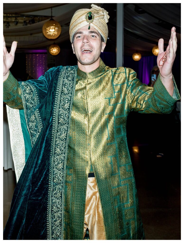 Groom in green sherwani dancing at reception – Indian wedding photography California – Leana Myra Photography