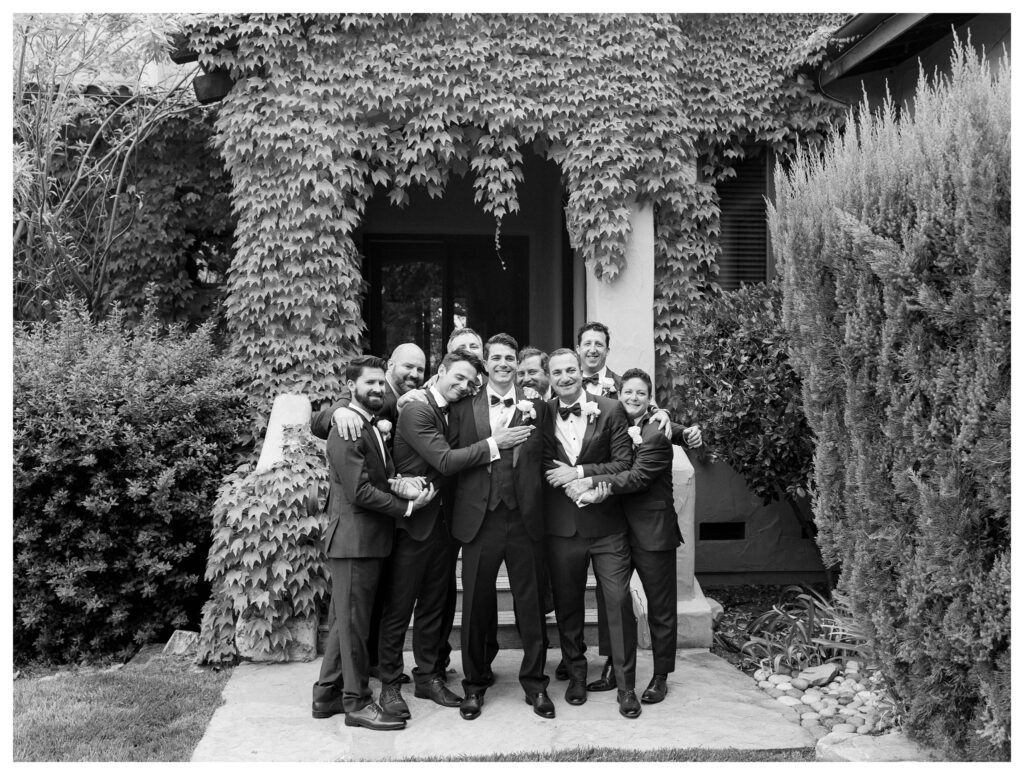 Stylish bridal party portrait with bridesmaids in peach saris and groomsmen in matching traditional outfits at Terra Mia Vineyards wedding in Paso Robles by Leana Myra Photography.