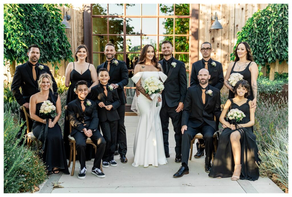 Wedding party taking vogue inspired photo during chic and elegant barn wedding at Marfarm, and San Luis Obispo Barn wedding venue.