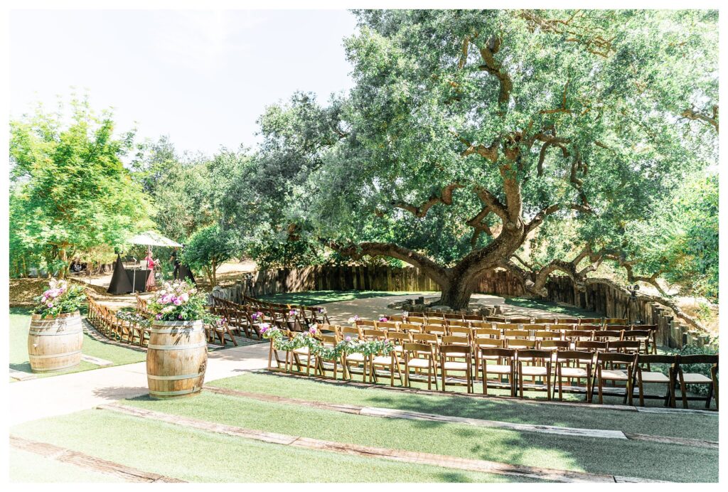 A ceremony set up under the oak tree at Hartley farms, a san luis obispo garden wedding venue. 