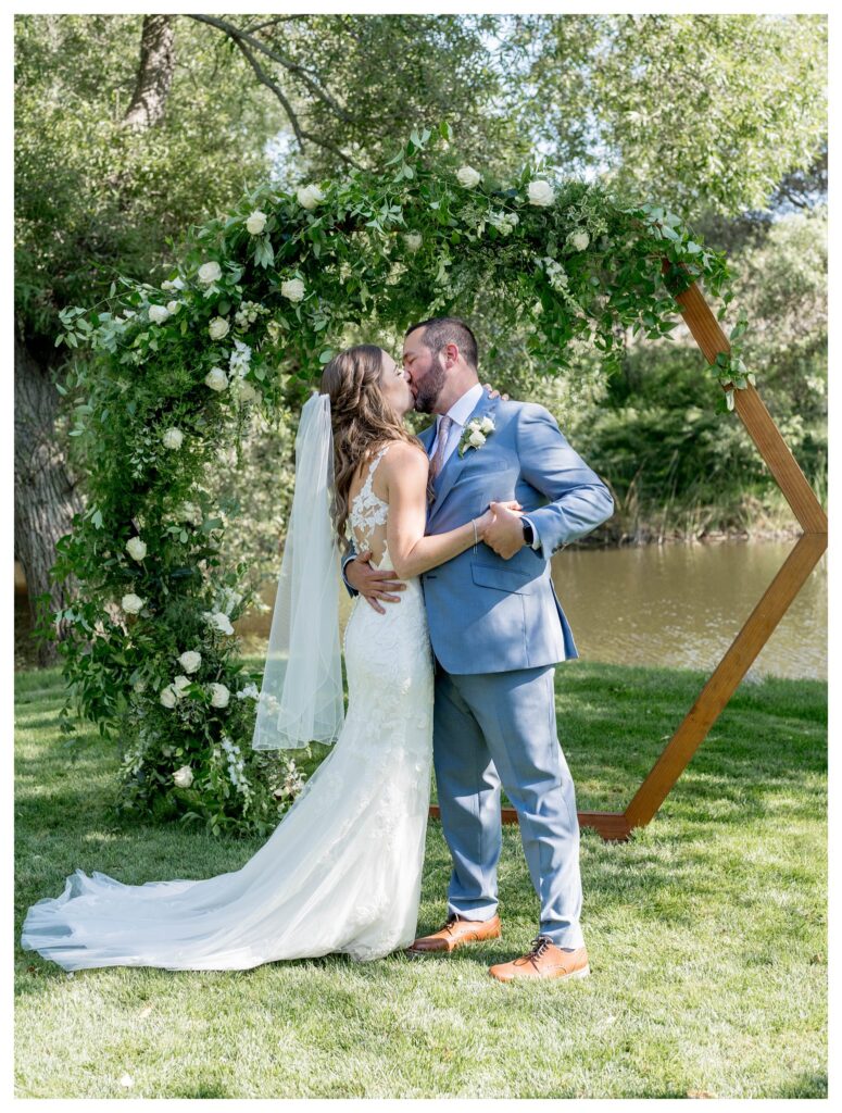 Bride and groom sharing a kiss at Greengate Ranch wedding ceremony - Paso Robles | Leana Myra Photography