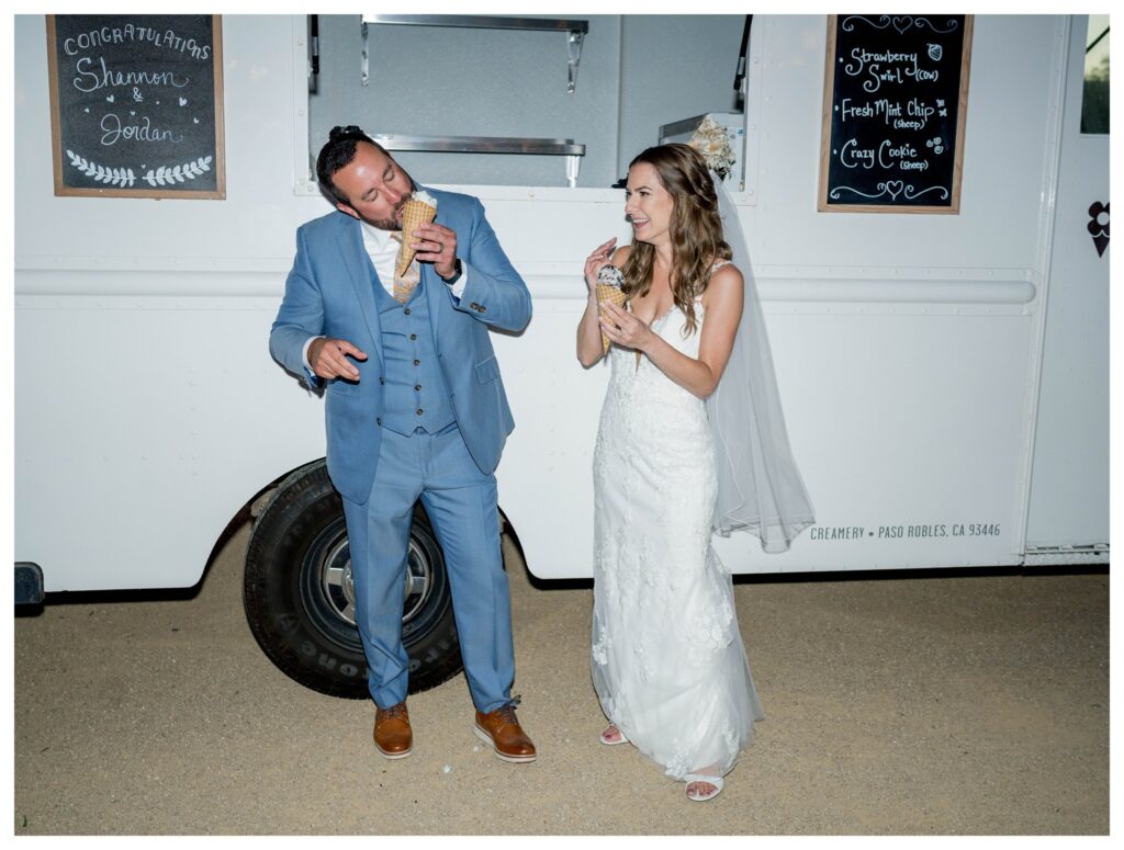 The couple enjoys a fun moment at an ice cream truck, laughing and sharing a sweet treat.