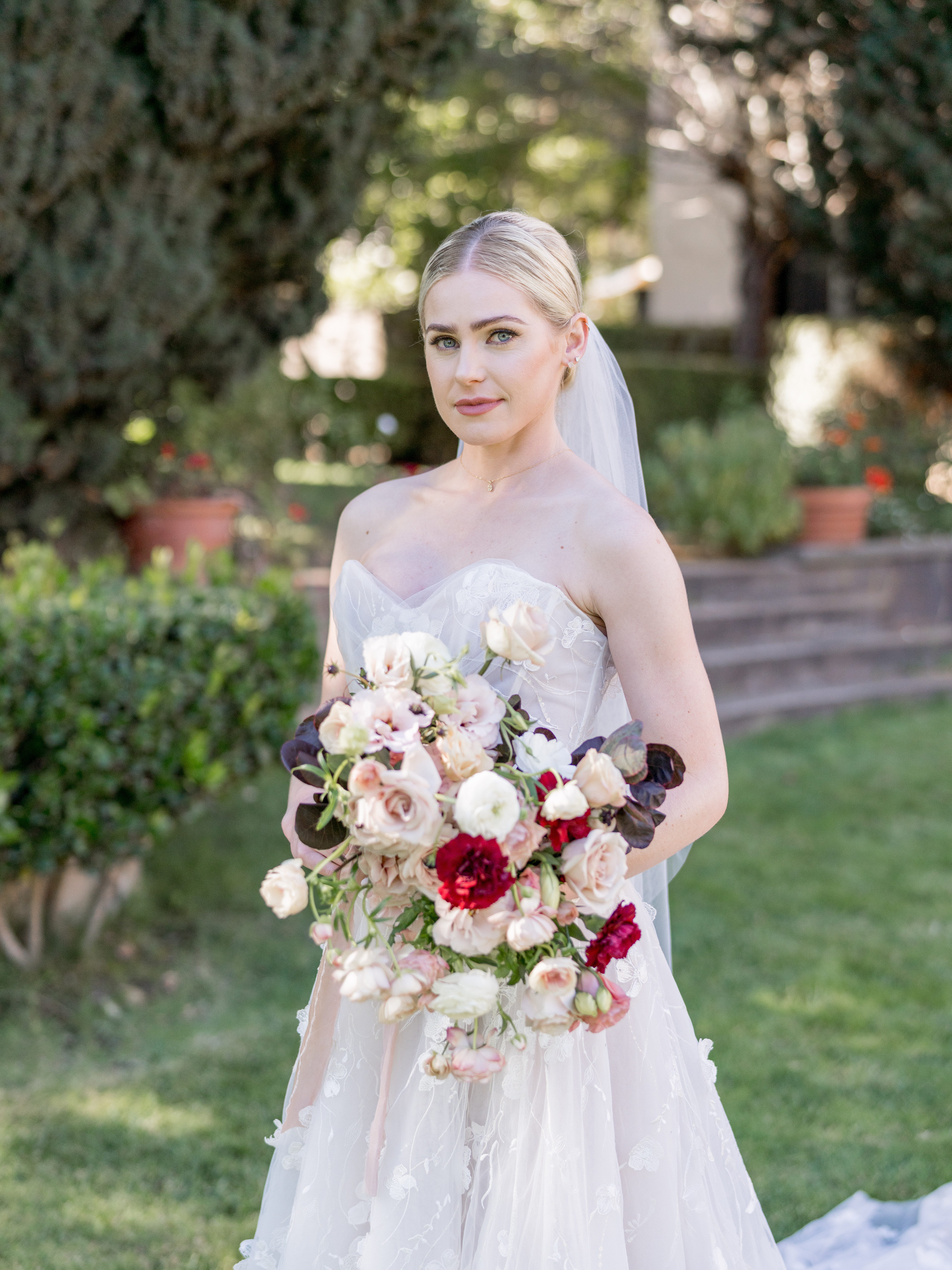 A bride holding a bouquet of elegant flowers after her beautiful and stylish wedding ceremony at the Santa Barbara Courthouse