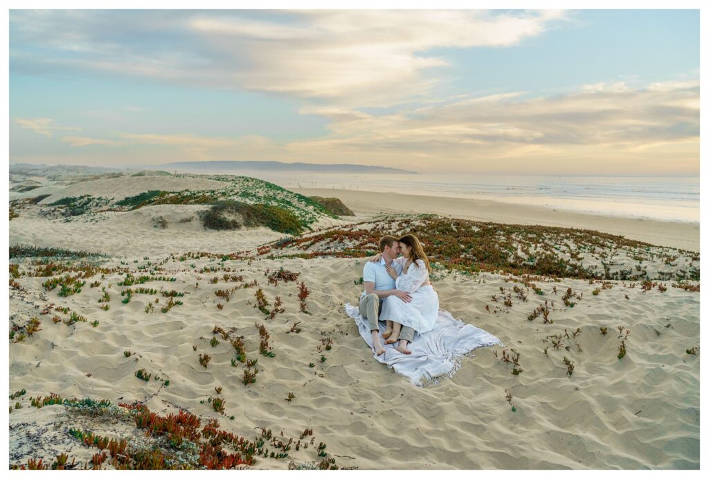 An engaged couple enjoying the sunset on the central coast beaches, a perfect spot for a destination wedding. 