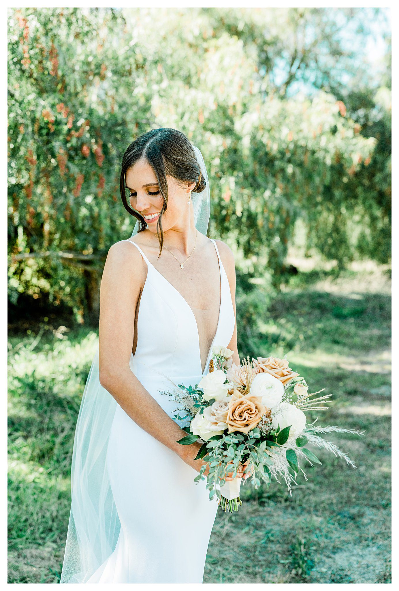 A bride at her Slo Brew Rock wedding in San Luis Obispo holding her boho bouquet of flowers.