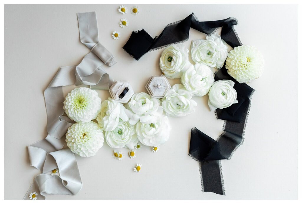 Flat lay of wedding details from a black and white themed luxury wedding at Maravilla gardens in Camarillo, by a light and airy wedding photographer. 
