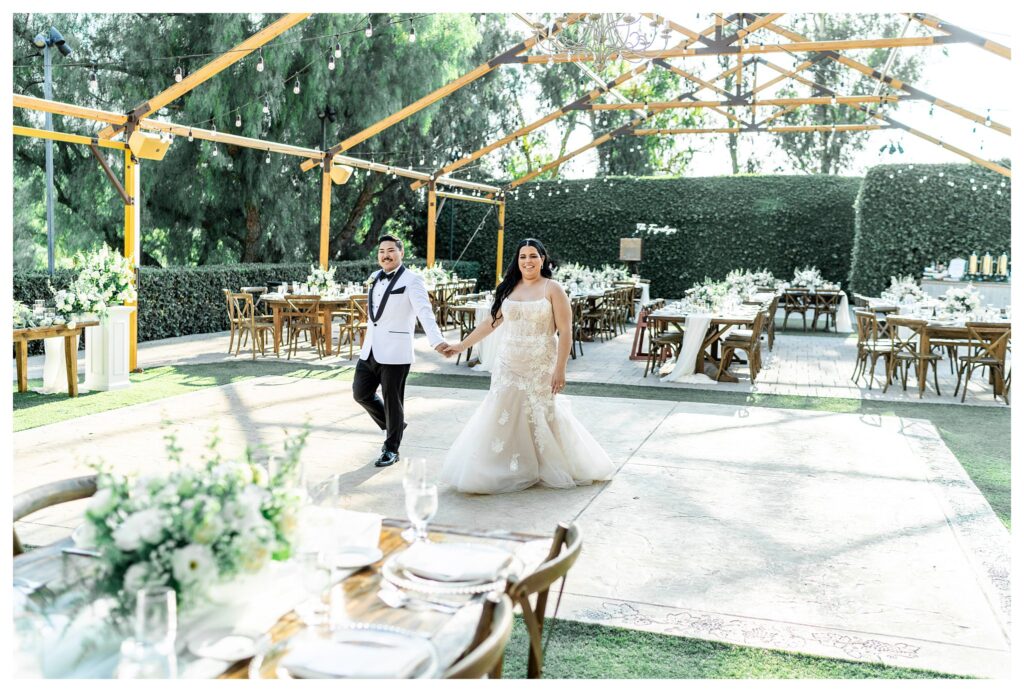 A bride and groom in elegant wedding attire at their luxury wedding at Maravilla gardens in Camarillo, by a light and airy wedding photographer. 