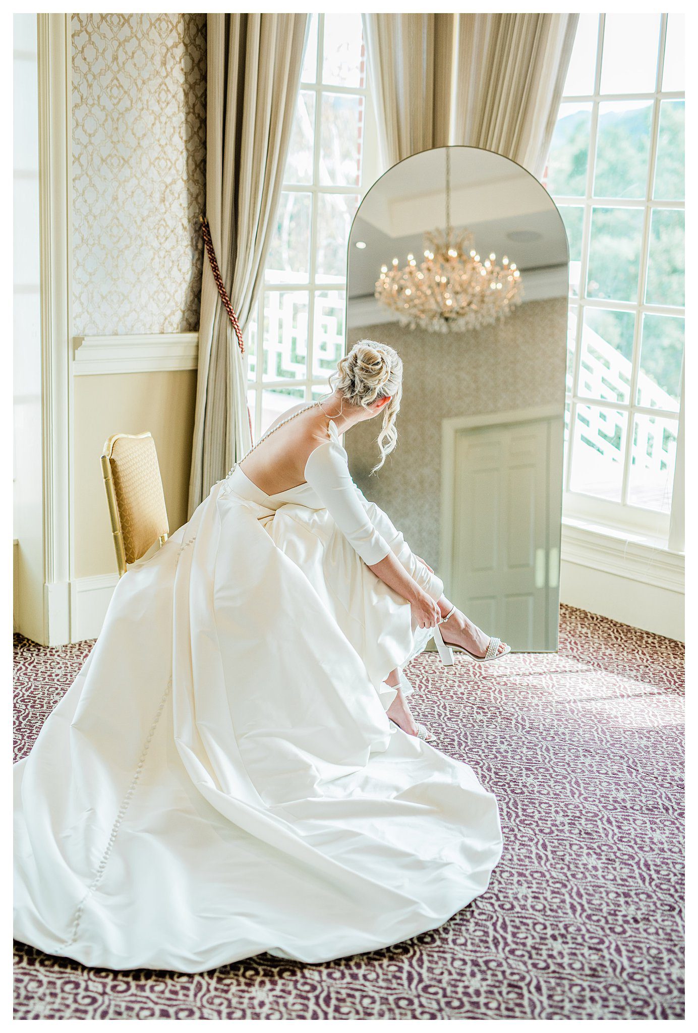 Bride looking into mirror in iconic pose before her Sherwood Country club luxury wedding. 