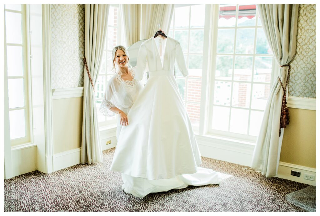 Bride holds up her wedding dress at Sherwood country club, a thousand oaks luxury wedding venue.