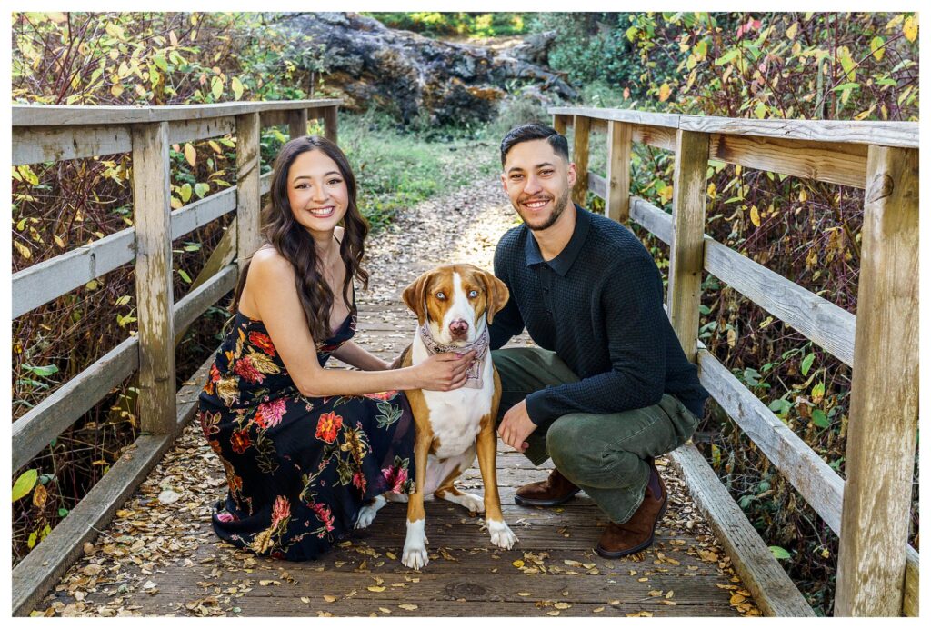 Brighten Groom smile at the camera with their dog at their candid engagement session at the Los Osos Oaks. Reserve in San Luis Obispo.