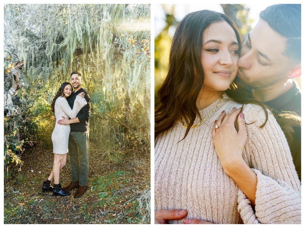 Man kisses woman passionately under a fairytale tree covered in moss with dreamy whimsical light flickering though during their candid engagement session in SLO.