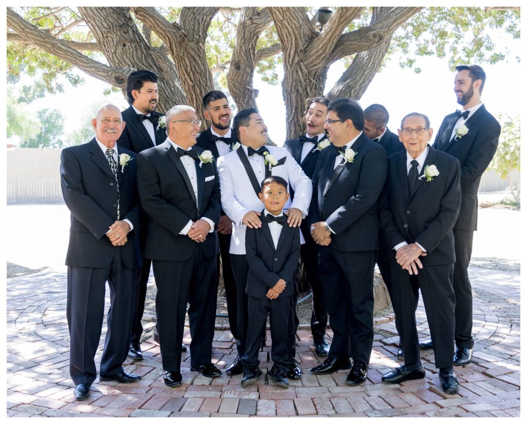 Groom with family across generations under tree at Maravilla Gardens, Camarillo.

