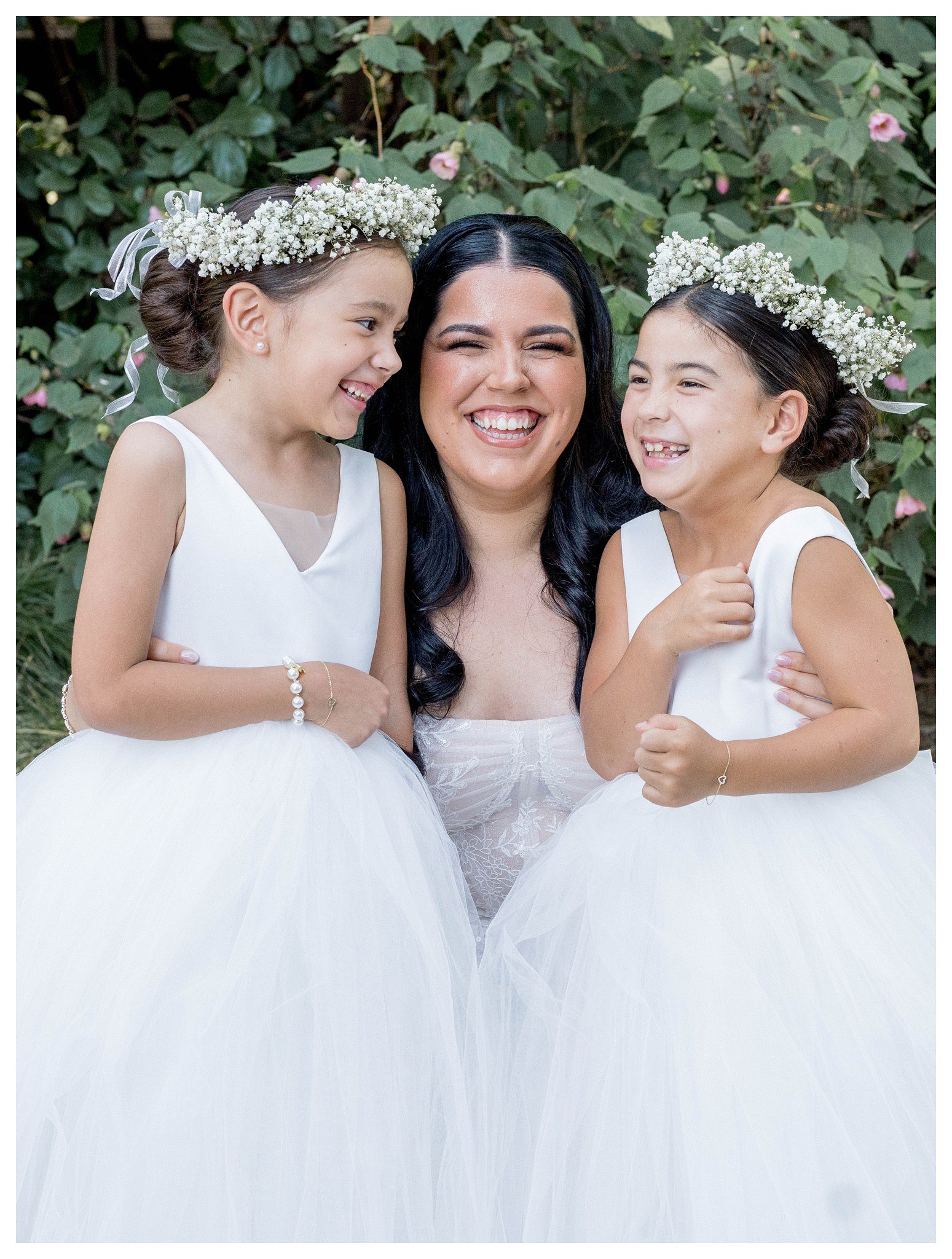 Joyful bride with flower girls in white dresses at Maravilla Gardens wedding in Camarillo.

