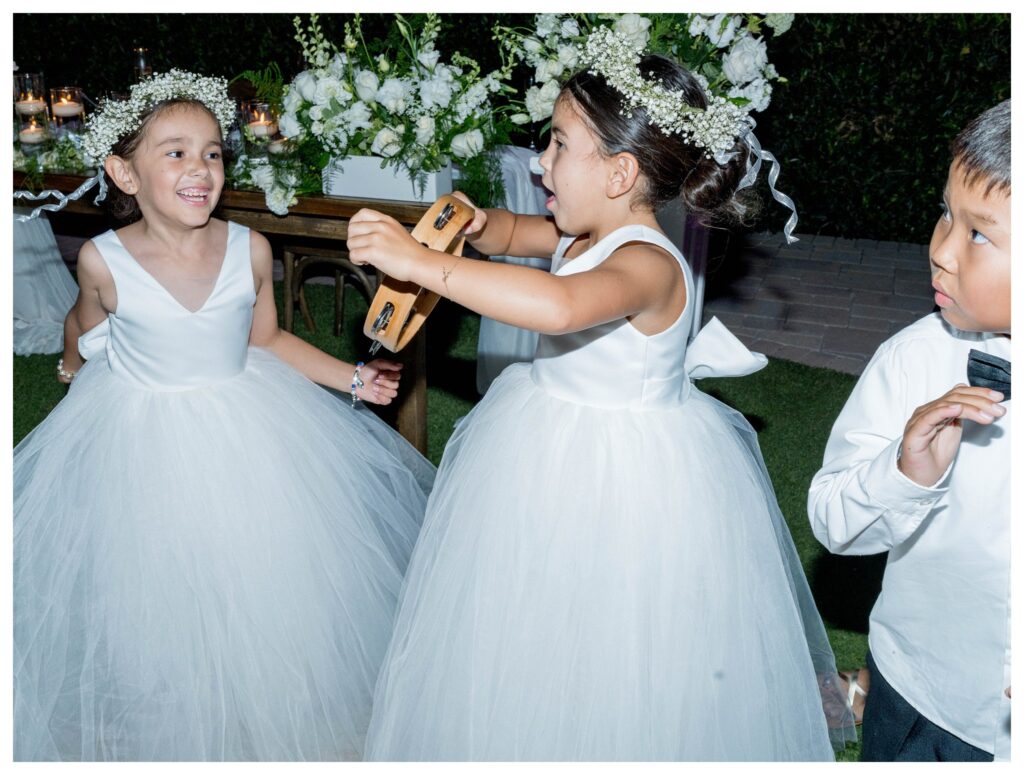 Flower girls playing with tambourine at Camarillo wedding