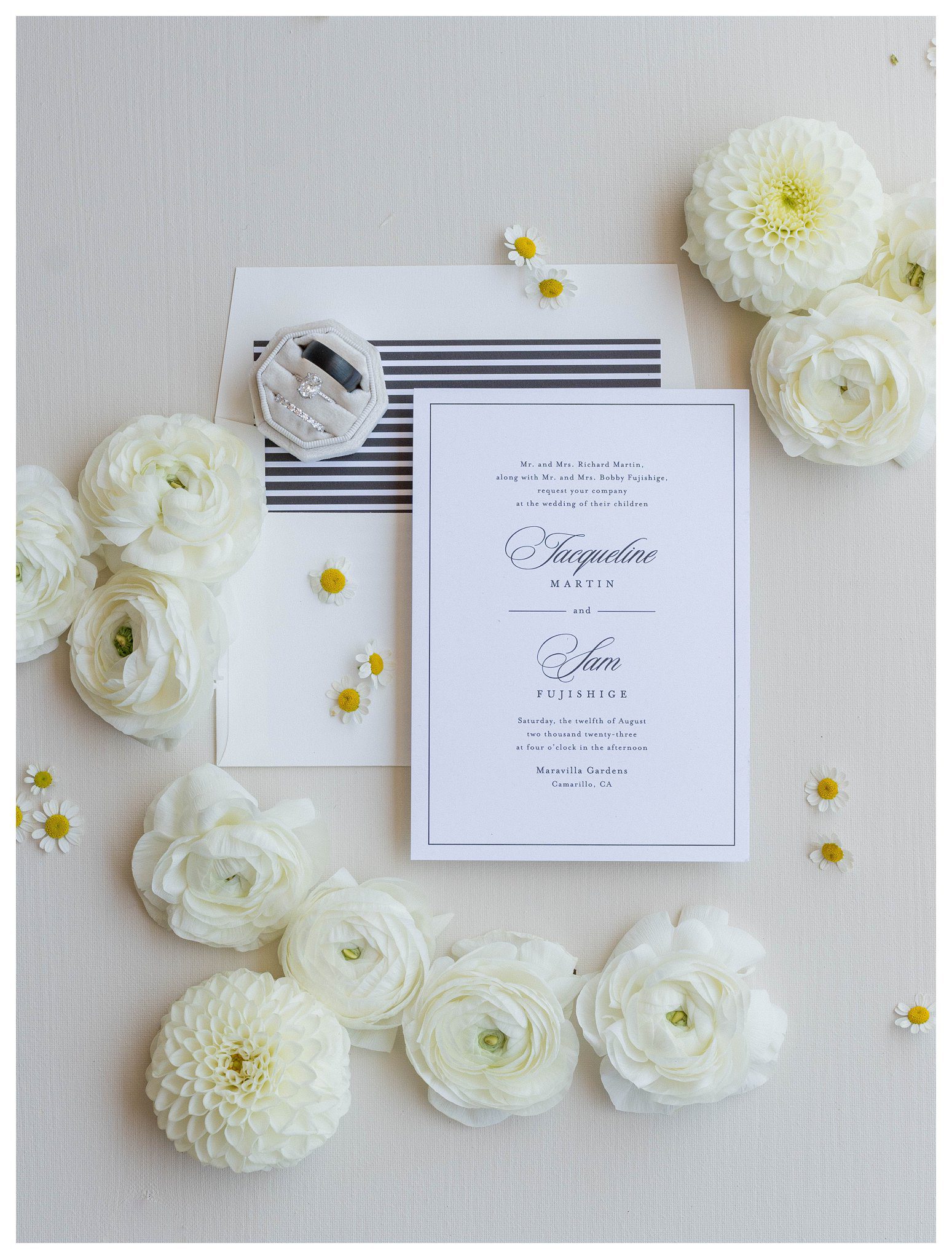 Elegant invitation suite with white florals and ring box at Maravilla Gardens in Camarillo.

