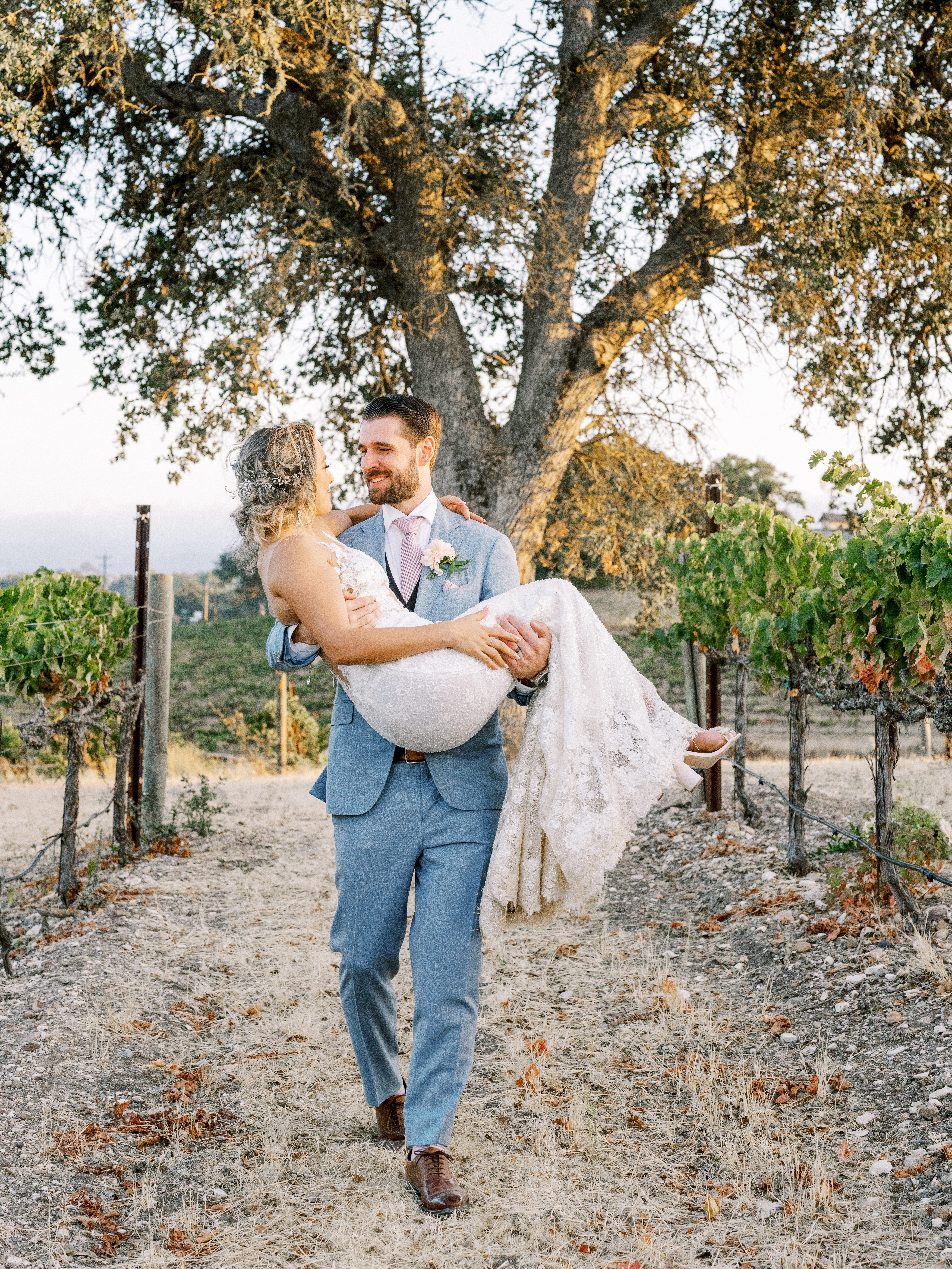 a bride and groom in the vines at sunset during their san luis obispo wedding