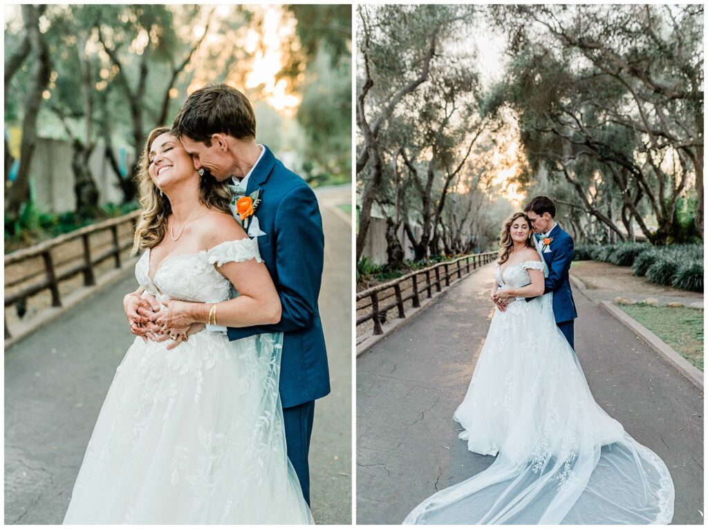 A bright and groom stand on the pathway at the Santa Barbara zoo in wedding attire during the sunset portion of their wedding day for romantic portraits together.