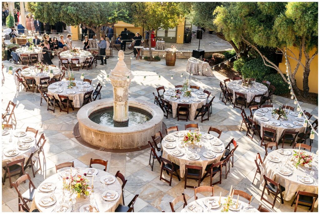 A wedding at Cali Paso, winery, and Villa in Paso Robles with reception tables decorated and gray place.