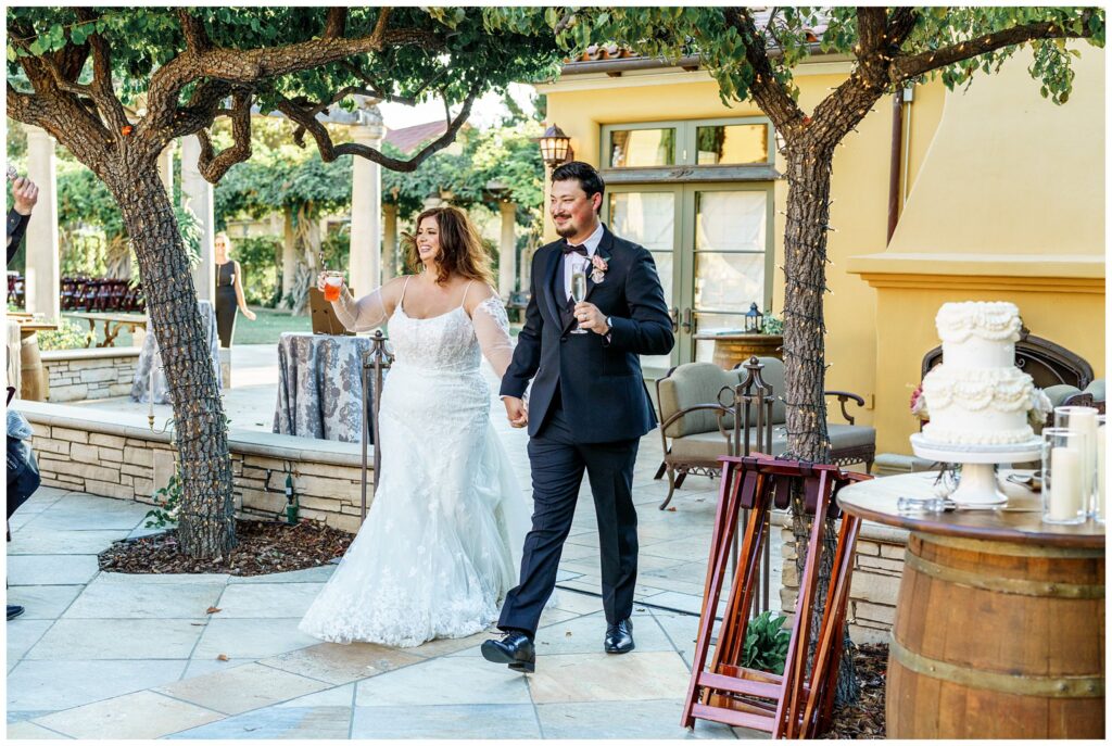 a bride and groom happily enter their wedding reception during their party, at Cali Paso, winery, and Villa.