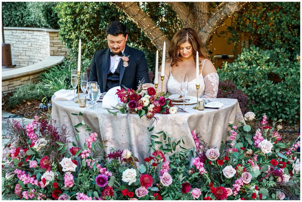 A bright and groom prayed during their wedding reception at Cali Paso, winery, and Villa in Paso Robles during their dinner.