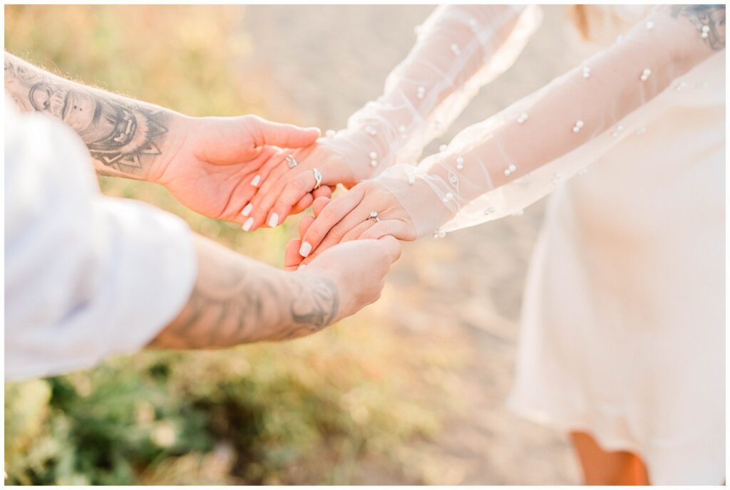 An engaged couple holding hands during their central coast engagement pictures. 