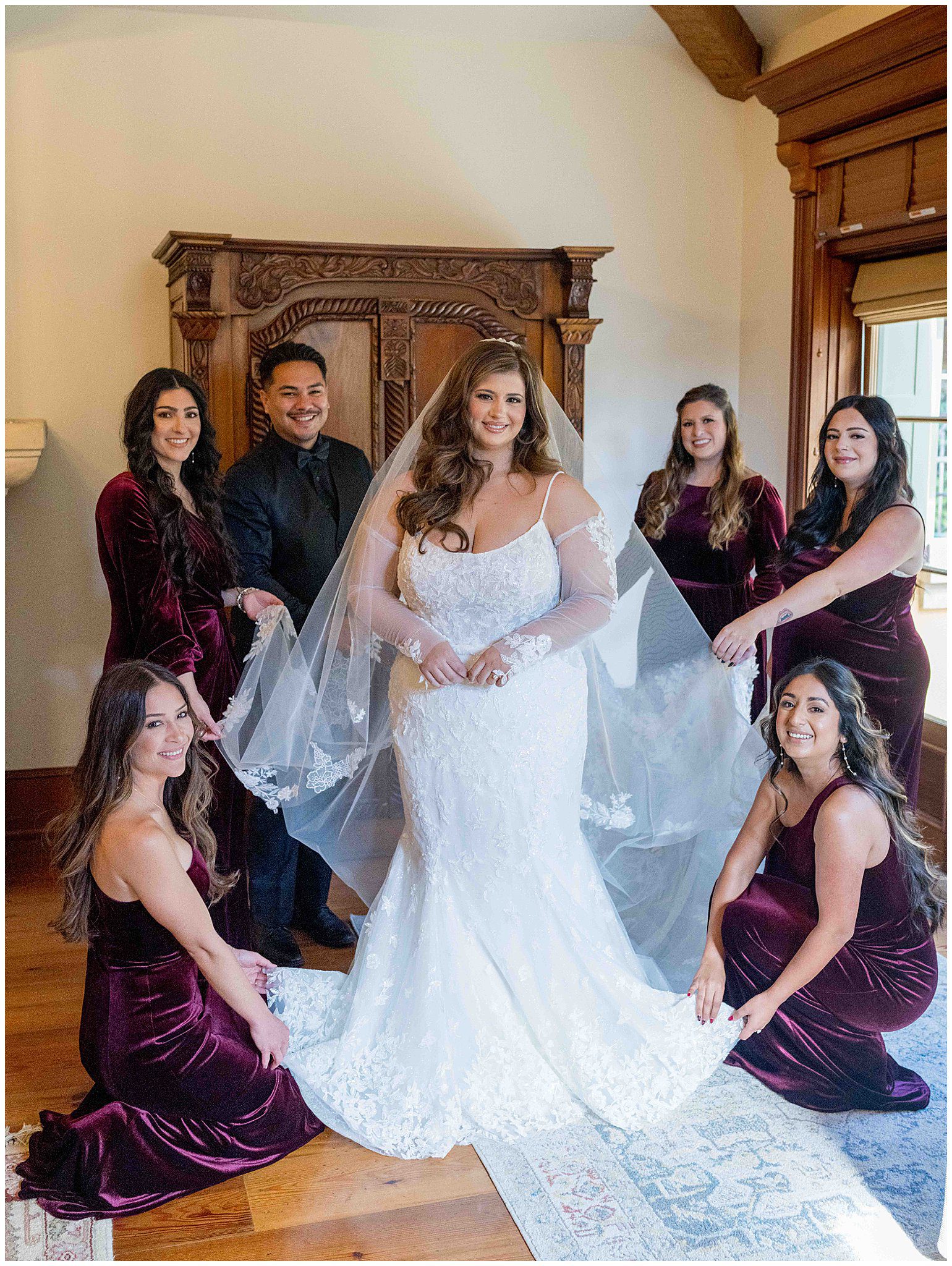 Bride surrounded by her bridesmaids, sharing joyful moments in a stunning bridal suite, captured with romantic light and elegance by Leana Myra Photography, Paso Robles wedding photographer.