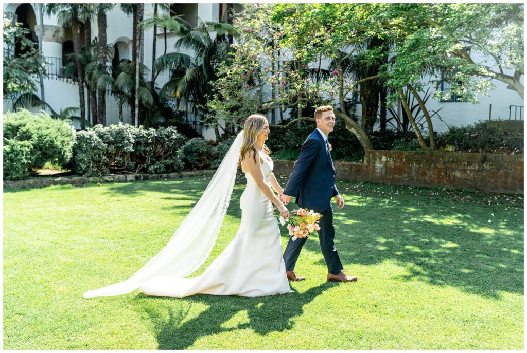 Bride and groom walking through the sunken gardens at the Santa Barbara Courthouse. 