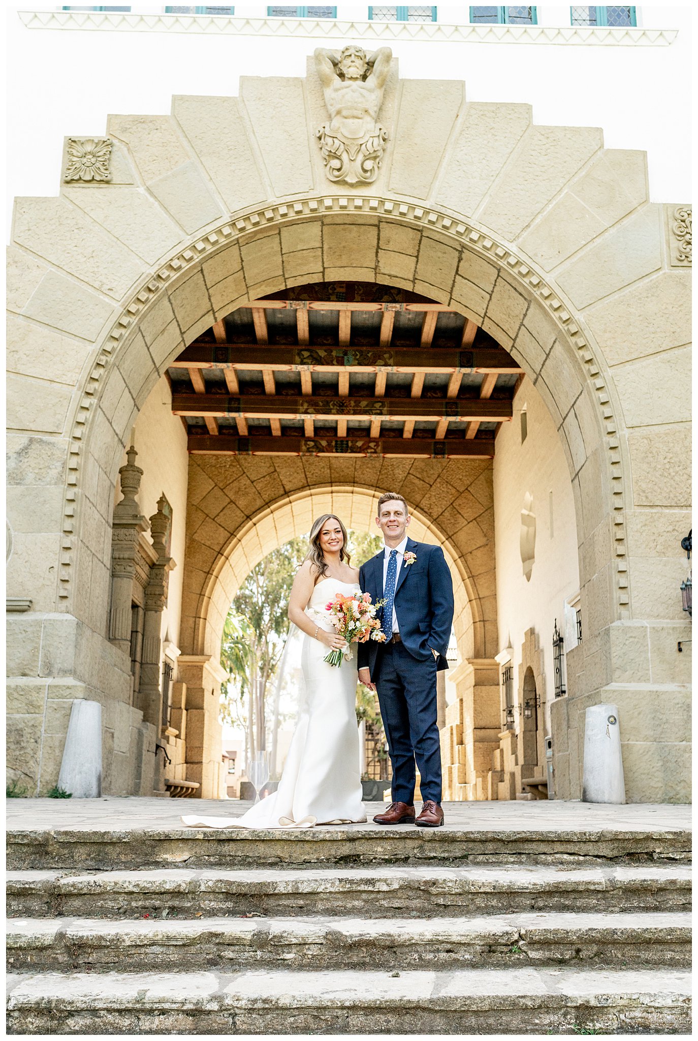 Bride and Groom stand in the archway at the Santa Barbara courthouse on their wedding day.
