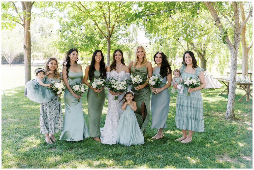 Bridesmaids at Bella Terra Vineyard in classic and elegant bridesmaids dresses in green and white.