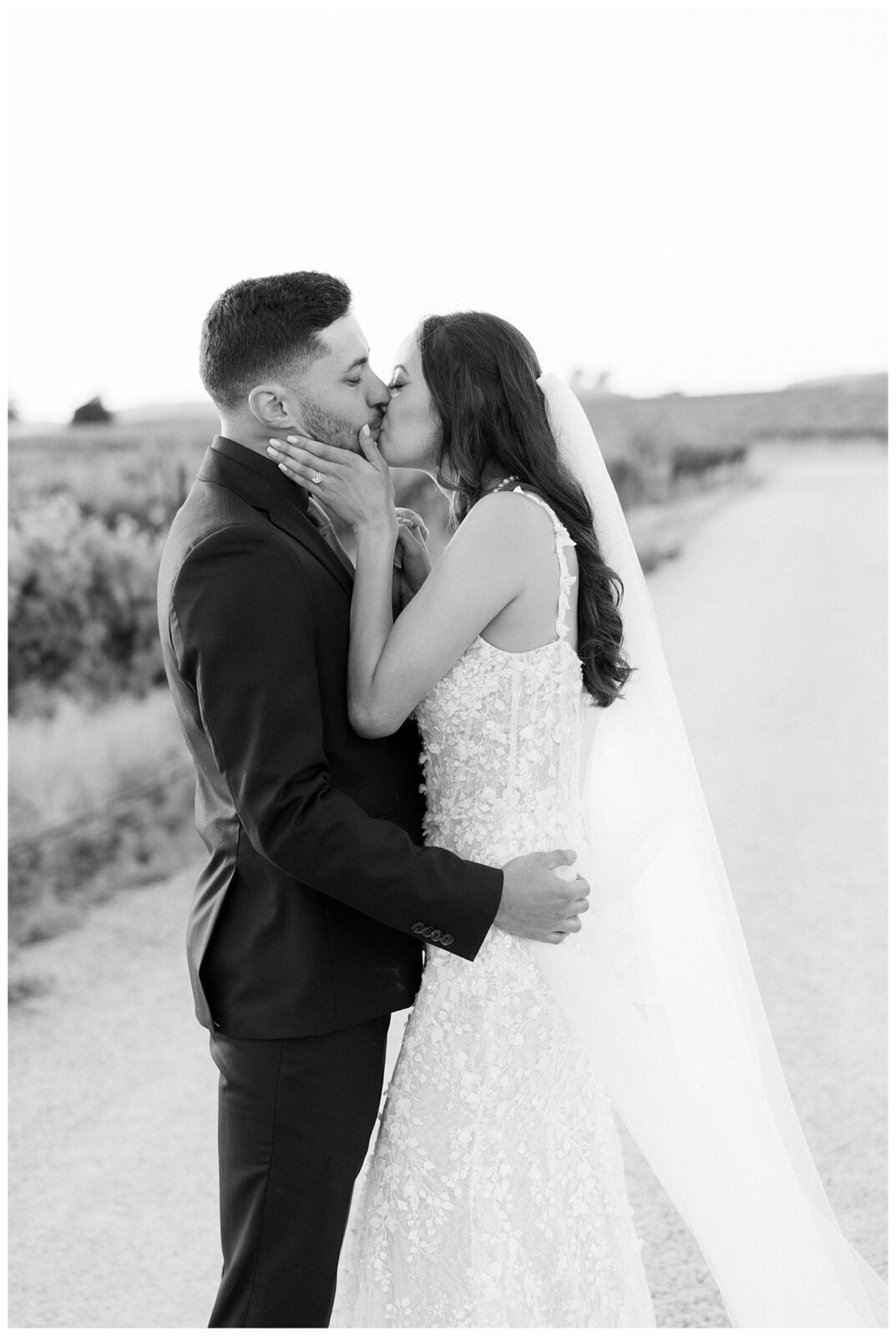 Bree and Groom passionately kiss in the vineyards during their Bella TERRA vineyards wedding day a beautiful outdoor garden wedding venue in Paso Robles California.