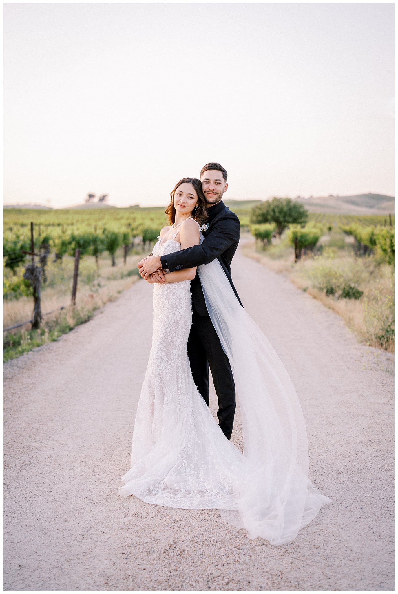 A bride and groom in the vineyards at Bella Terra on their springtime wedding day.