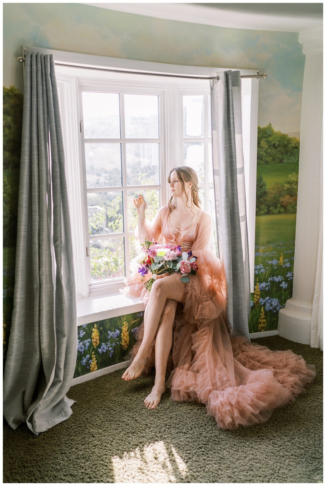 Bride reclines on window seat at Chateau Noland during her getting ready photos for her wedding. 