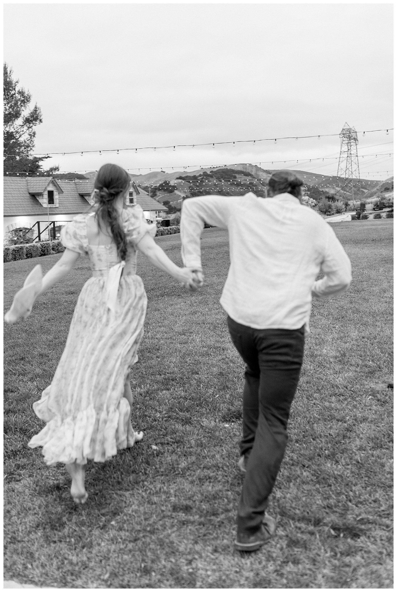 a man and woman holding hands and running after they got engaged at a castle in california