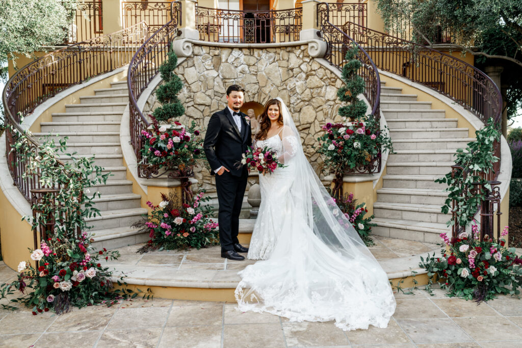 Bride and Groom pose on steps at an elegant Cali Paso Winery wedding.