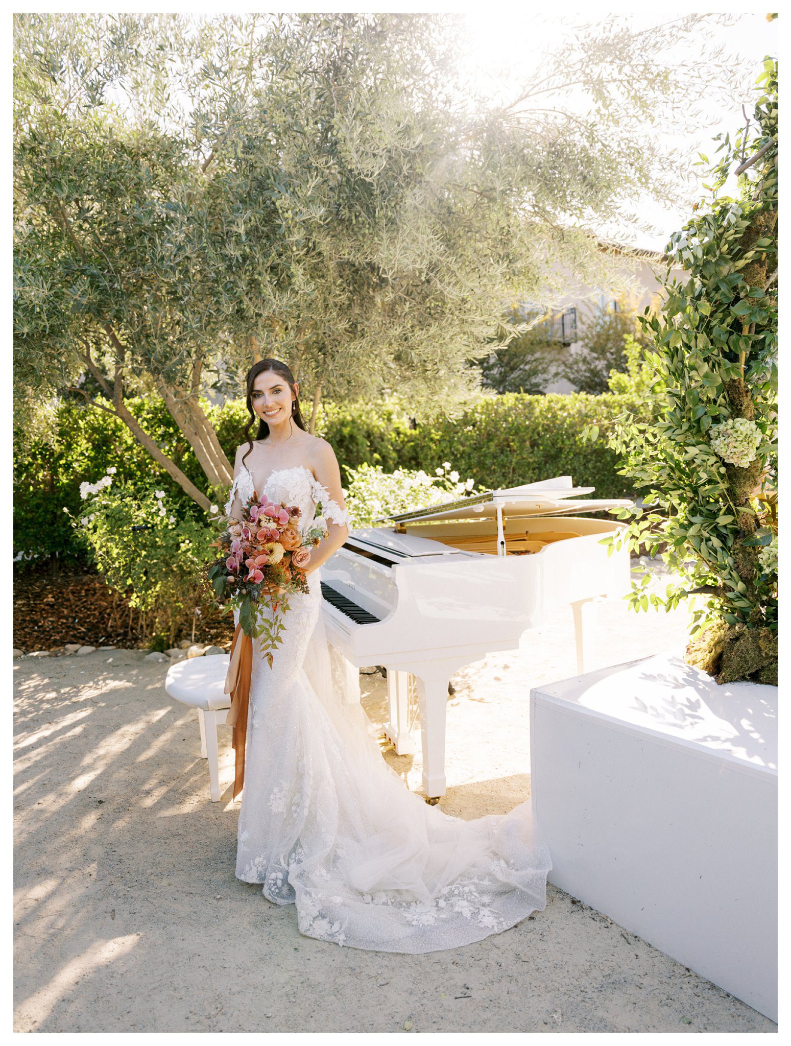 romantic bride posing with bouquet by white piano,