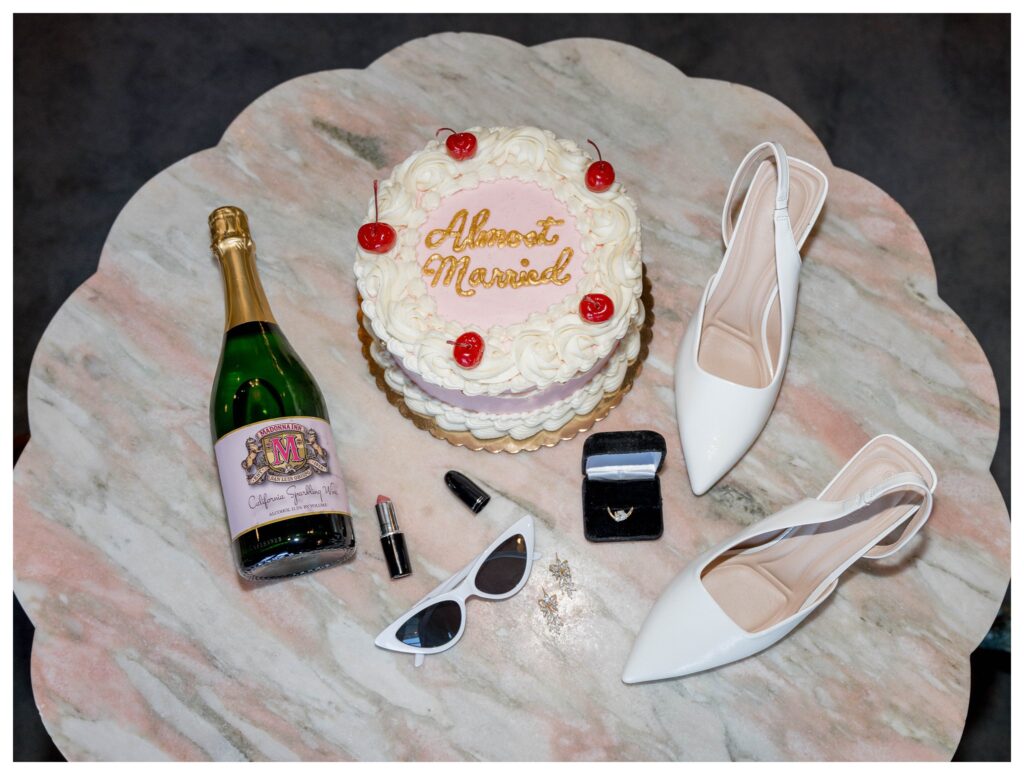Flat lay with shoes + book – Wedding Details | Madonna Inn | Leana Myra Photography