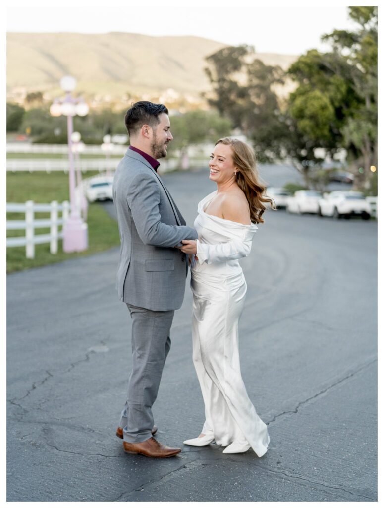 Couple laughing in street – Playful Bride | Madonna Inn Wedding | Leana Myra Photography