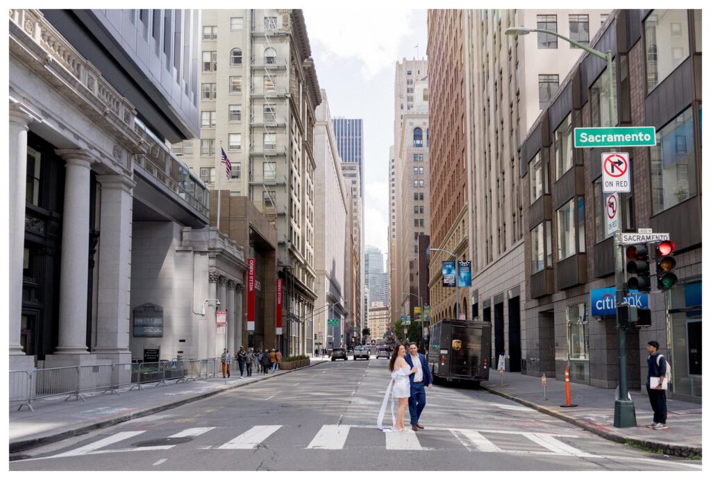 Man and woman in downtown San Francisco taking engagement photos by San Francisco photographer Leana Myra.