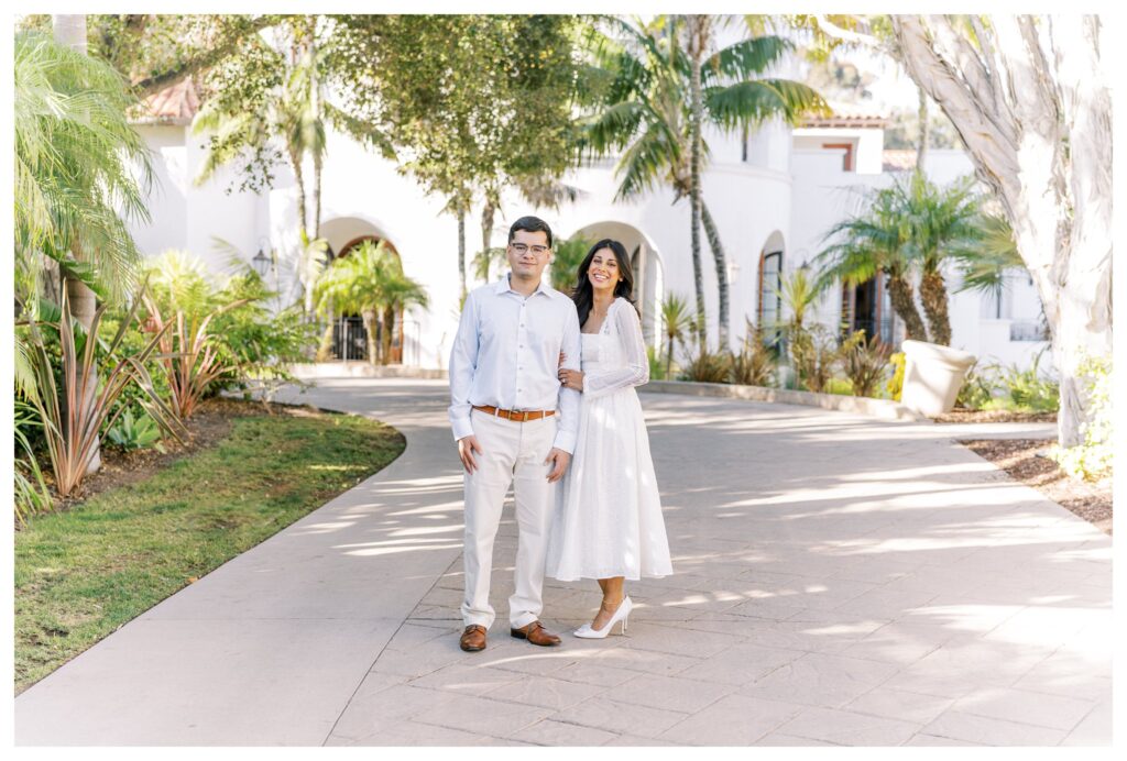 Elegant couple posing on the palm-lined entrance of the Ritz-Carlton Bacara during their Santa Barbara engagement session