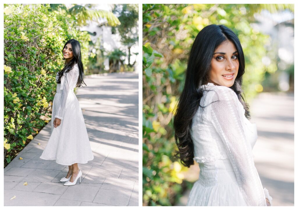 Bride-to-be in classic white eyelet dress smiling over shoulder with tropical greenery at the Ritz-Carlton Bacara